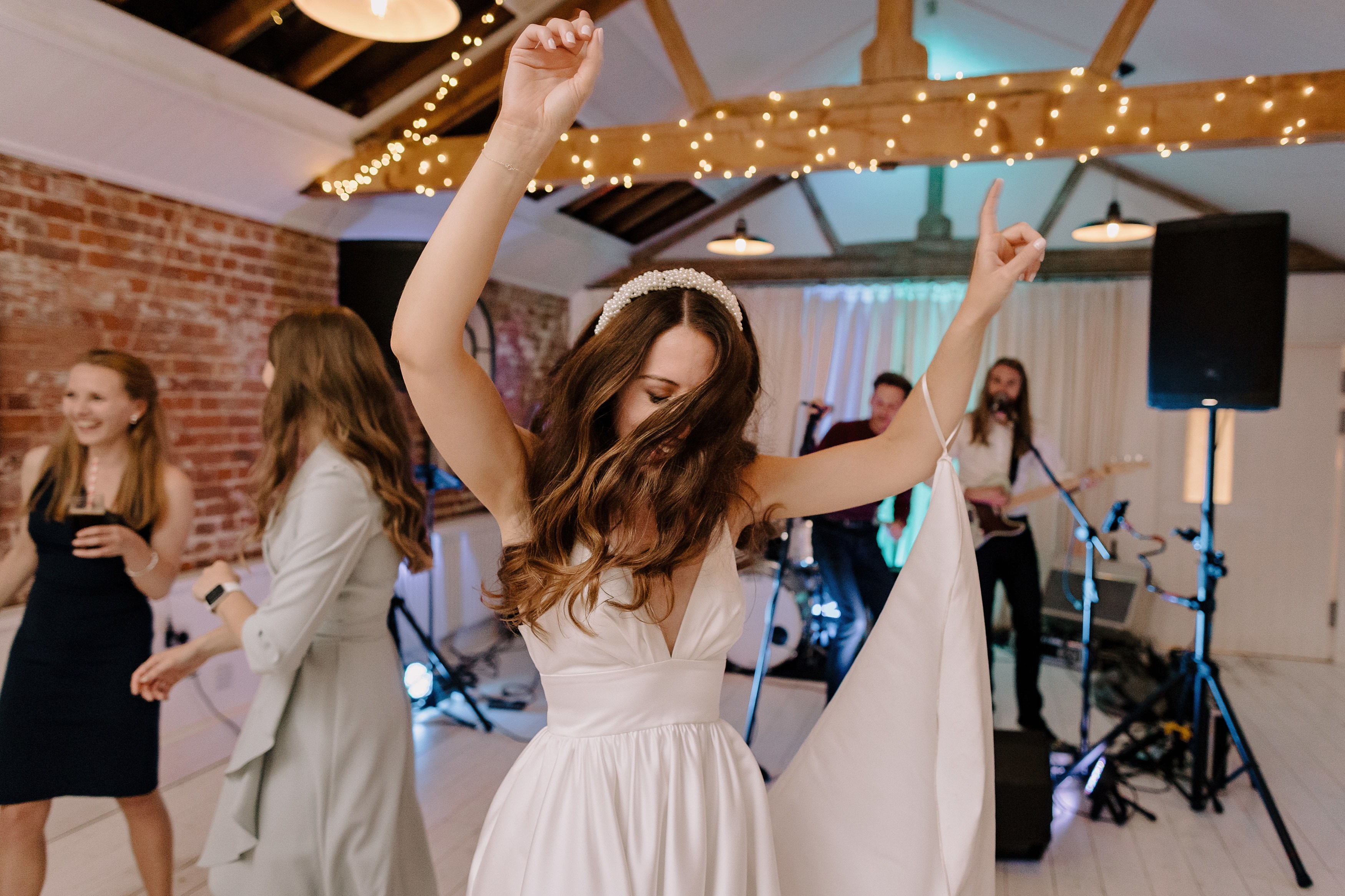 The bride dancing enthusiastically by herself