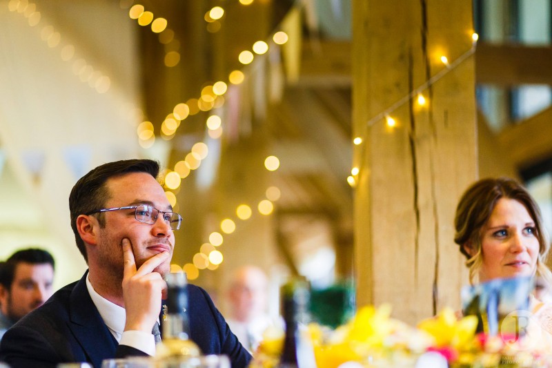 Brother in law listens to speech from the bride