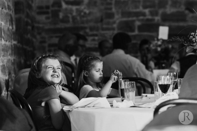 Little girl smiling at her mum in wedding venue in Uckfield