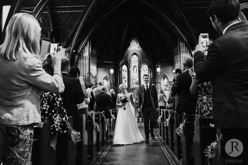 Anna &amp; Pete walking out of St John's Church Hildenborough after their wedding ceremony.